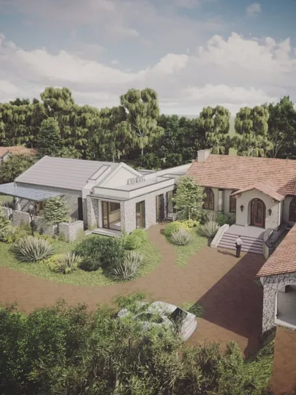 An aerial view of "The Abbey House" render, emphasizing its connection to the surrounding landscape and the way it breaks down its large scale into a more human-centric collection of buildings.