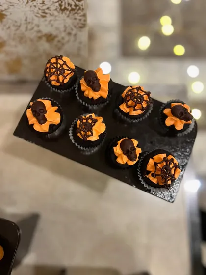 Spooky and delicious Halloween-themed cupcakes I made for a party. The orange frosting and chocolate skull toppers were a big hit.