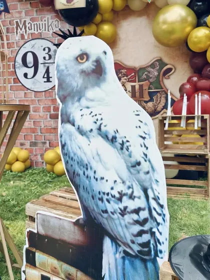 A large cutout of Hedwig the owl, one of the many custom props I created for this magical Harry Potter party.