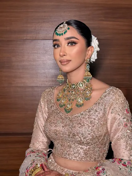 A close up of this elegant look. The makeup is soft and natural, with a focus on enhancing her features.