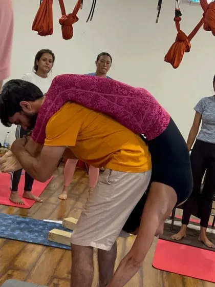 Partner adjustments are a key part of our YTTC. Students learn how to safely assist each other in deep stretches and poses.