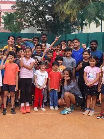 The whole crew together. Teaching the right techniques is important, but creating a positive and challenging environment is what I love most about being a tennis coach.