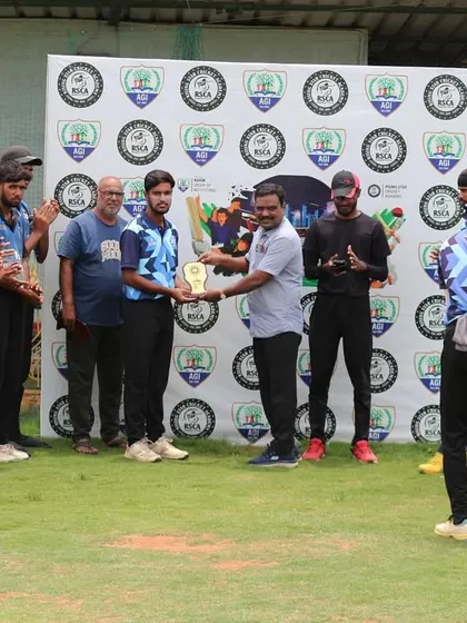 A player from the winning team is presented with an award by an official during the ceremony.