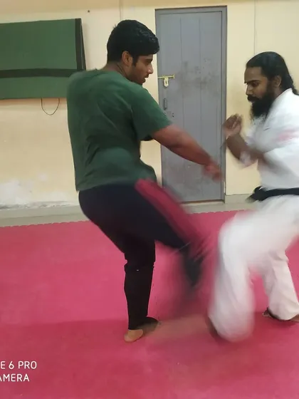 This action shot shows a kick exchange during a training session, highlighting the speed and intensity of our drills.