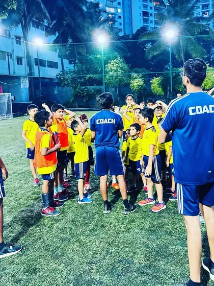 Coaches and players in a huddle. We foster an environment of open communication and mutual respect.