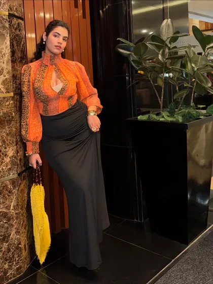 The full thrifted look. I paired the busy top with a simple black maxi skirt to balance it out. It’s all about creating harmony in your outfit.