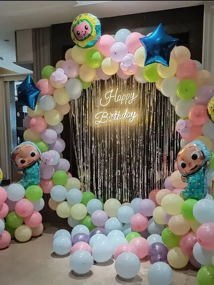 Another angle of the Cocomelon birthday setup, showing the full circular arch and the scattered balloons on the floor that kids love to play with.