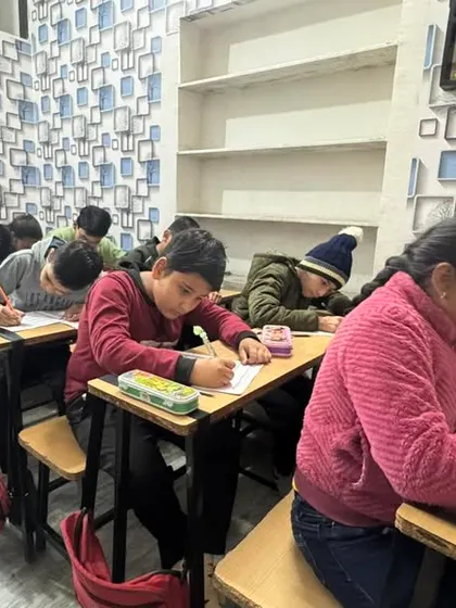 Students focused on their work at the Dausa center. Our program builds discipline and concentration.