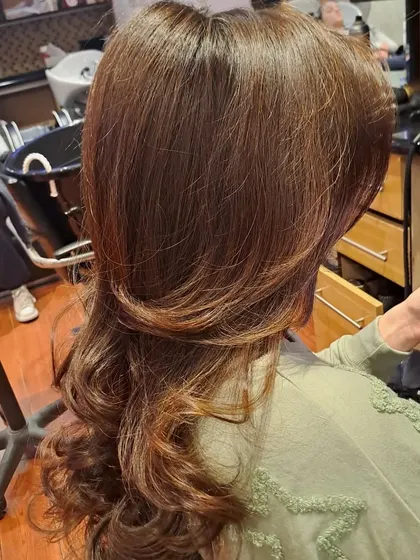 The back view of the layered cut and blowout. You can see the distinct layers that create shape and reduce weight, allowing for maximum volume.