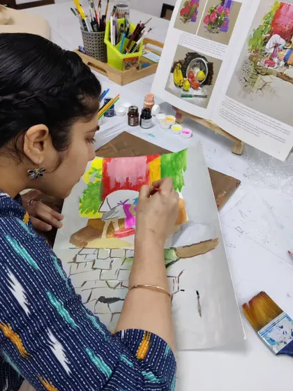 This shot shows the student carefully painting the stone pavement, focusing on the texture and perspective of the scene.
