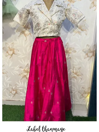A full view of the pink lehenga and white blazer top, a great fusion look for parties.