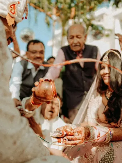 A close-up of a traditional ritual during the wedding ceremony, highlighting the cultural details and family involvement.