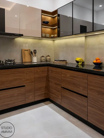 This kitchen combines the warmth of wood with a clean, modern aesthetic. The lower cabinets are finished in a rich wood grain, while the upper cabinets are a mix of glossy white and glass. Under-cabinet lighting provides excellent task lighting and highlights the stone backsplash.
