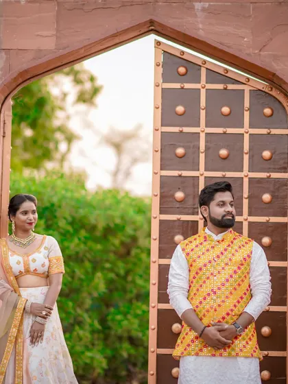 Another take on the grand doorway portrait, this time with the couple looking in different directions, creating a stylish and thoughtful composition.