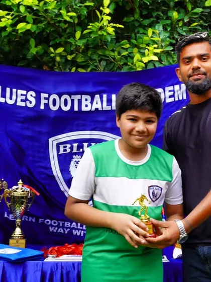Our U12 goalkeeper proudly accepts his award. His performance was key to his team's success in the tournament.