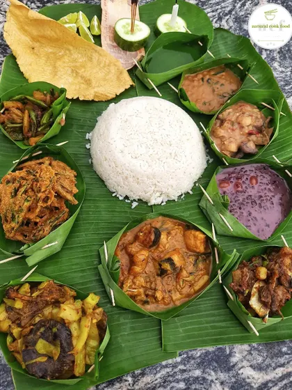 For the Manipuri New Year, 'Cheiraoba', I prepare a traditional feast served in 'lai' (banana leaf bowls). This platter includes 'Sareng thongba' (fish curry), 'chak-hao kheer' (black rice pudding), and crispy 'bora'.
