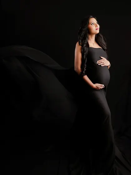 A duplicate of image 1, this powerful and dramatic solo portrait uses moody lighting to create a stunning silhouette against a black background.