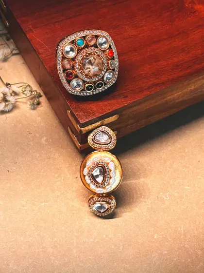 Two of our most popular statement rings, one a Navratna-style square design and the other a vertical three-stone piece.