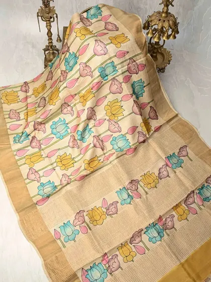 A full view of the multi-colored lotus Pen Kalamkari saree, showing the repetition of the beautiful hand-painted pattern. The natural texture of the silk enhances the artwork.