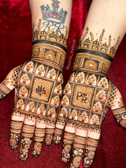 I love incorporating personal touches, like the couple's initials "PR", into the bridal design. This architectural pattern with lotus motifs is a wonderful example of blending modern personalization with timeless tradition.