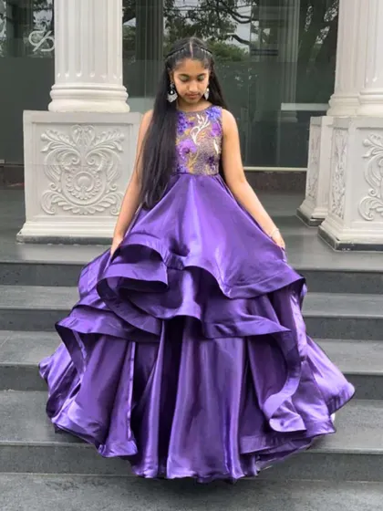 My client looks like a princess in her custom purple gown. The combination of a detailed bodice and a full, flowing skirt makes it a truly special occasion dress.