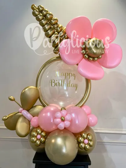 A beautiful floral-themed birthday balloon bouquet in pink and gold, perfect for a sophisticated and feminine celebration.