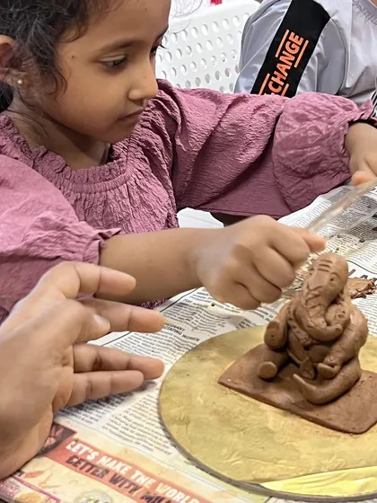 Tiny hands, big creativity. I love helping our youngest participants add the final touches to their clay Ganesha, fostering a connection to art and culture from an early age.