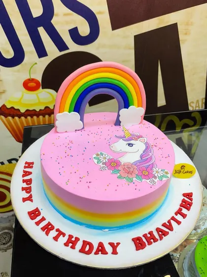 A pretty pink 2kg unicorn cake with a rainbow and an edible unicorn print.