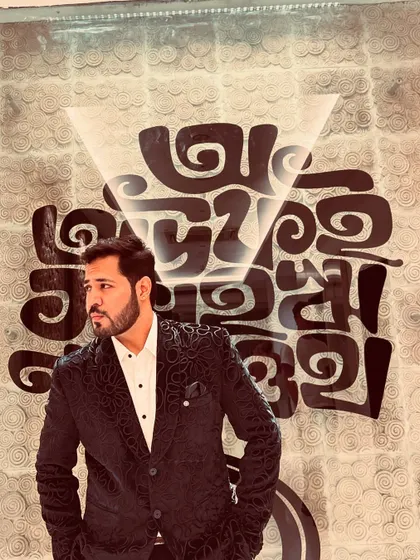 A thoughtful profile shot in a patterned blazer, showing a more contemplative side.
