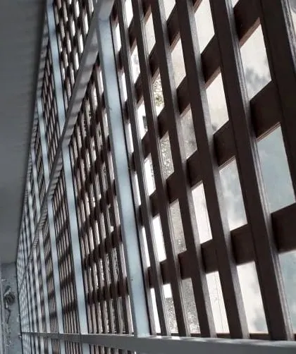 A side view of the Tipwood jaali screen, showing how it is mounted to create a functional and decorative layer over the building's exterior.