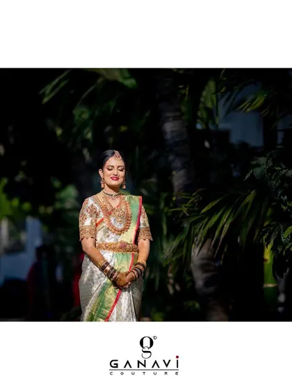 Our bride Rishika, diligently glammed up for her big day in our ethnic couture. Her off-white Kanjeevaram saree is paired with a blouse that is a masterpiece of embroidery, perfectly complementing the grandeur of the saree.