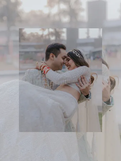 A groom lovingly carrying his bride. This classic wedding portrait is filled with happiness and romance, captured in a candid style.