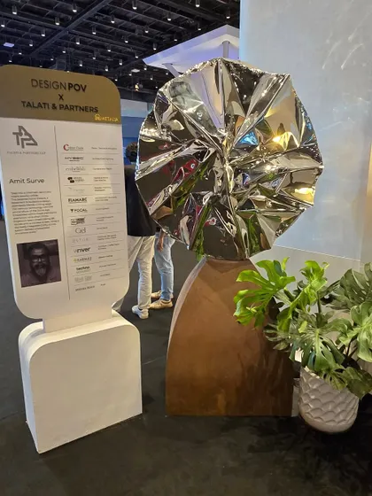 My sculpture "Eclipse" featured at the Design POV exhibition. Its placement next to a plant highlights the contrast between its industrial materials and organic forms.