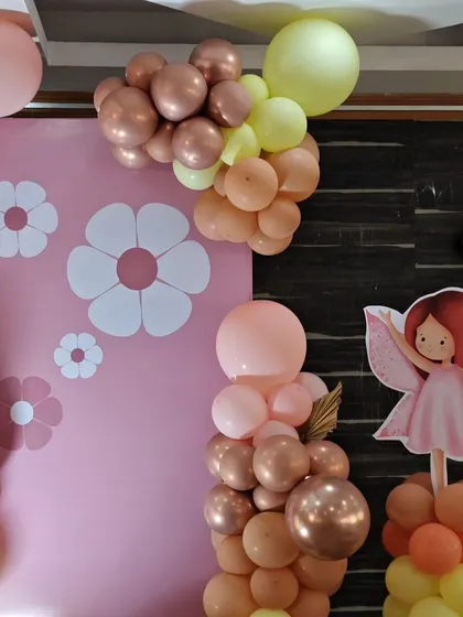 A detail of the balloon decor and floral-themed backdrop from Nithiksha's party.