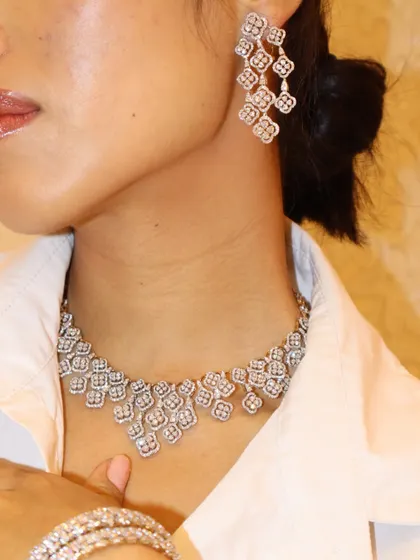 Iced out in TMJ. This look features a diamond cluster necklace with matching chandelier earrings, perfect for a bride or a grand celebration.