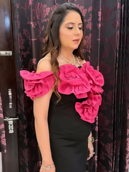 A side profile showing the soft contour and glowing highlight of her party makeup. The look is sophisticated and perfect for an evening event.