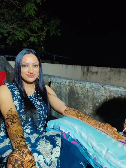 A beautiful shot of a client enjoying her completed mehndi. The rich, dark stain is already developing, a guarantee I provide to all my brides.