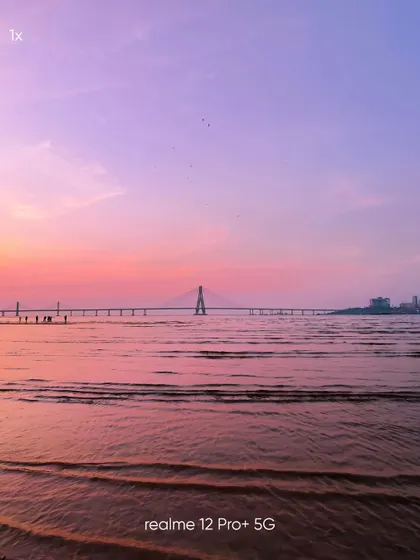 A standard 1x view of the Sea Link from the beach. This mobile photograph serves as a perfect reference point for the various zoom shots, showing the scene as the eye would naturally see it.