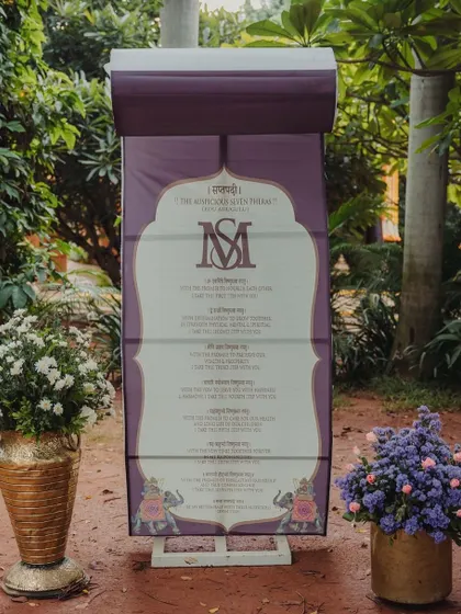 A custom itinerary board for a traditional wedding, designed with classic motifs and elegant script.