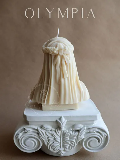 The back of the Veiled Lady candle, showing the intricate details of the veil's folds and the bow in her hair. Every angle of this sculpture is designed to be beautiful.