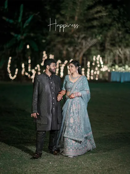A romantic evening portrait of the couple at their reception, the word "Happiness" perfectly describing the moment.