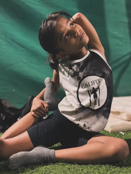 This young athlete is making great progress with her king pigeon pose, a deep stretch for the quads and hip flexors.
