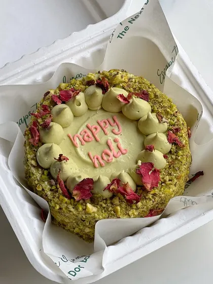 Another design for my Holi special mini cake. This one is a Thandai Pistachio cake, generously coated in crushed pistachios and decorated with dried rose petals for an elegant touch.