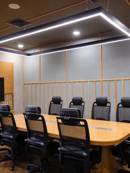A conference room at Anthea Pharma where acoustics played a pivotal role. The room features a traditional chattayi ceiling, teakwood beading, and acoustical wall boards, creating a space that is both visually striking and sonically balanced.