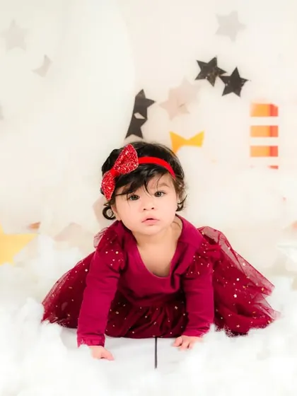 A baby girl crawls through a dreamy landscape of clouds and stars, on an adventure in her own imagination.