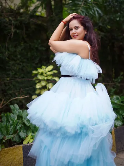 Another beautiful pose in the sky blue ruffle gown, showcasing its stunning design and flattering silhouette.