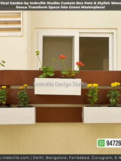 A vertical garden made of white box planters mounted on a dark wooden fence. This is a stylish and modern way to add greenery to a backyard wall.