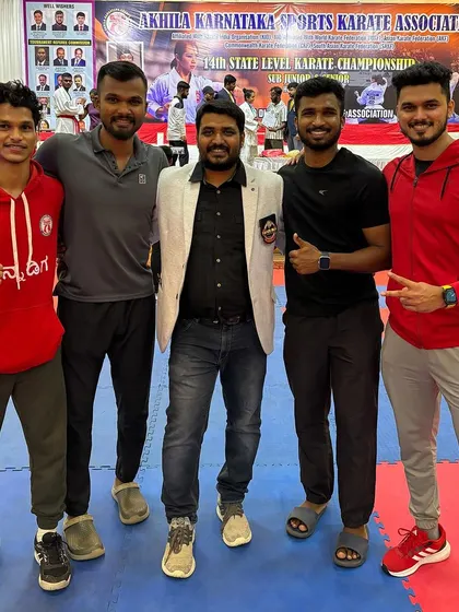 A group photo of the coaching and support team at the state championship in Hubli.