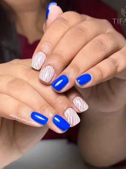 This vibrant blue and zebra print design is a perfect example of a fun, statement-making manicure that you will learn to create in our courses.