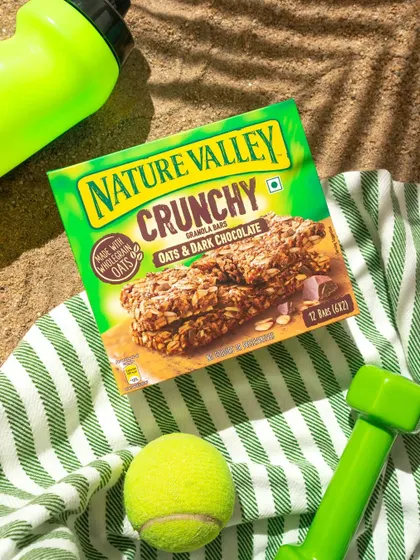 A beach-themed lifestyle shot for Nature Valley, created entirely in our home studio. We used sand, a striped towel, and fitness props to build a scene that feels sunny, active, and outdoorsy.
